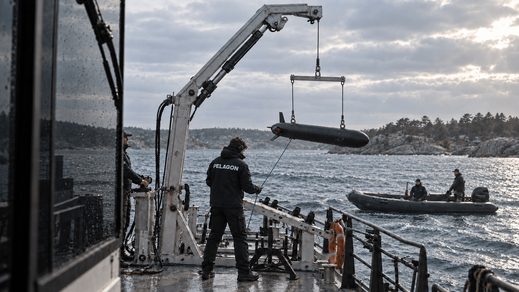 Pelagon crew recovering MARLIN from a vessel in Swedish coastal waters, with a support boat nearby